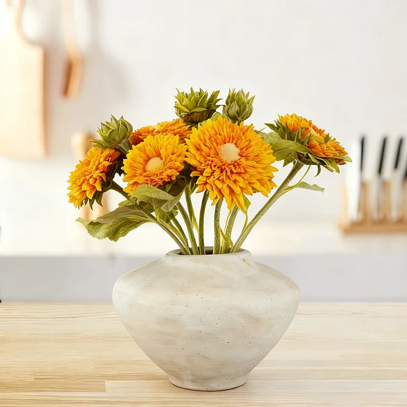 Off-white rounded ceramic vase with flowers; flowers not included